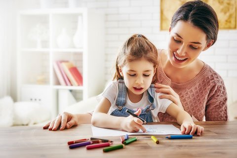 Parent and young child enjoying a simple learning activity together
