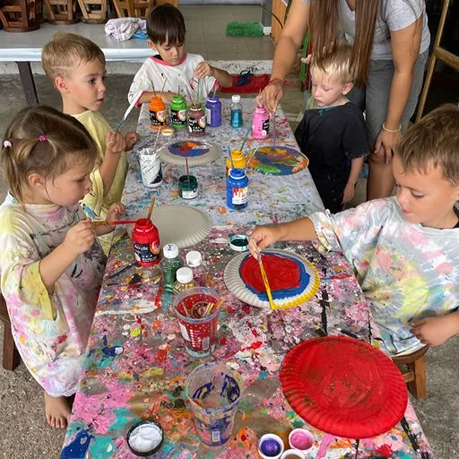 Teacher guiding a small group of children during an early learning activity in Kamala