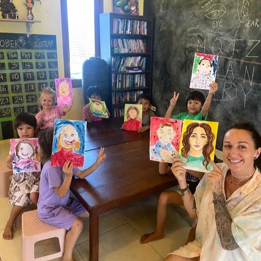 Children taking part in a self-portrait art activity at Shining Stars School Kamala